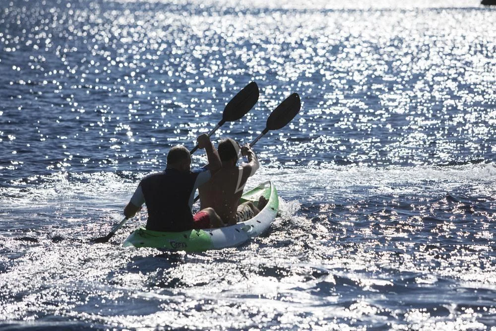 a group of people on a sled in the water with a shark aboard ANASA Yacht for Sale