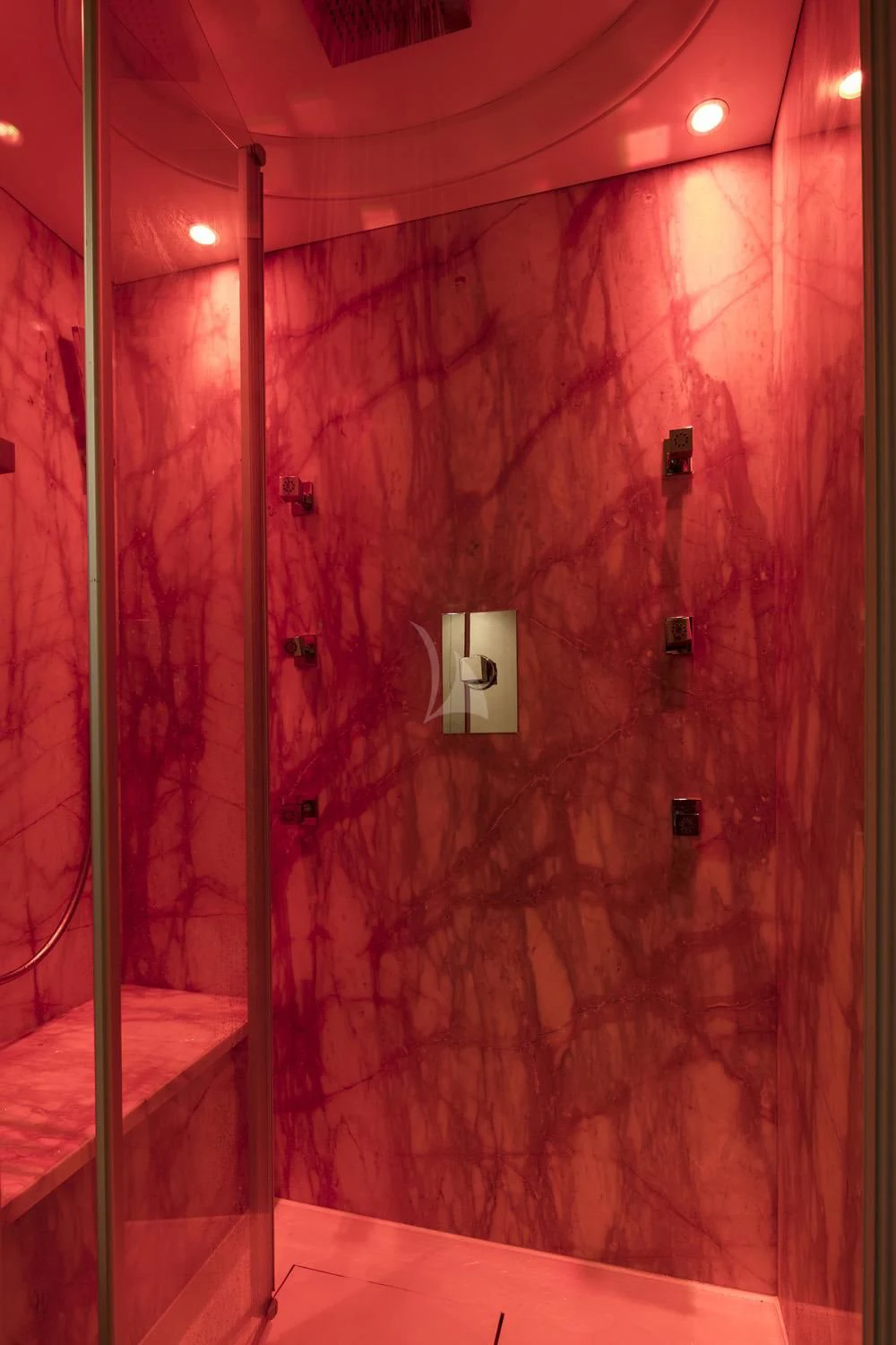 a shower with a wall of pink and white tiles aboard ANASA Yacht for Sale