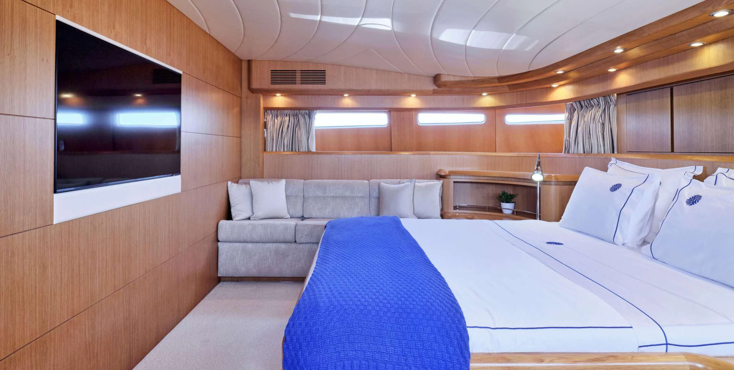 a room with a bed and a television aboard ANASA Yacht for Sale