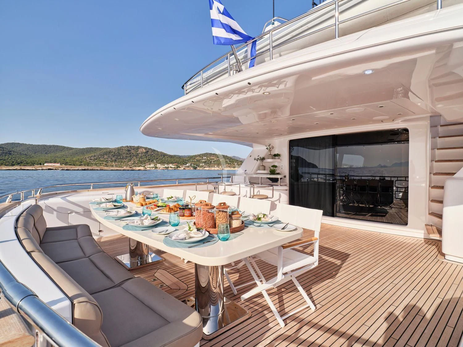 a table set for a meal on a boat on the water aboard ANASA Yacht for Sale