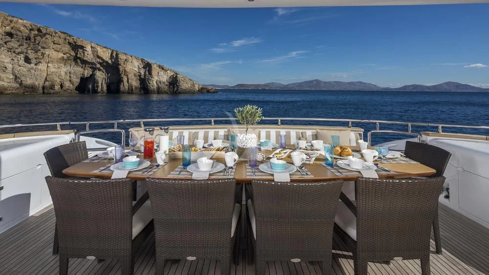 a table set for a meal on a beach aboard ANASA Yacht for Sale
