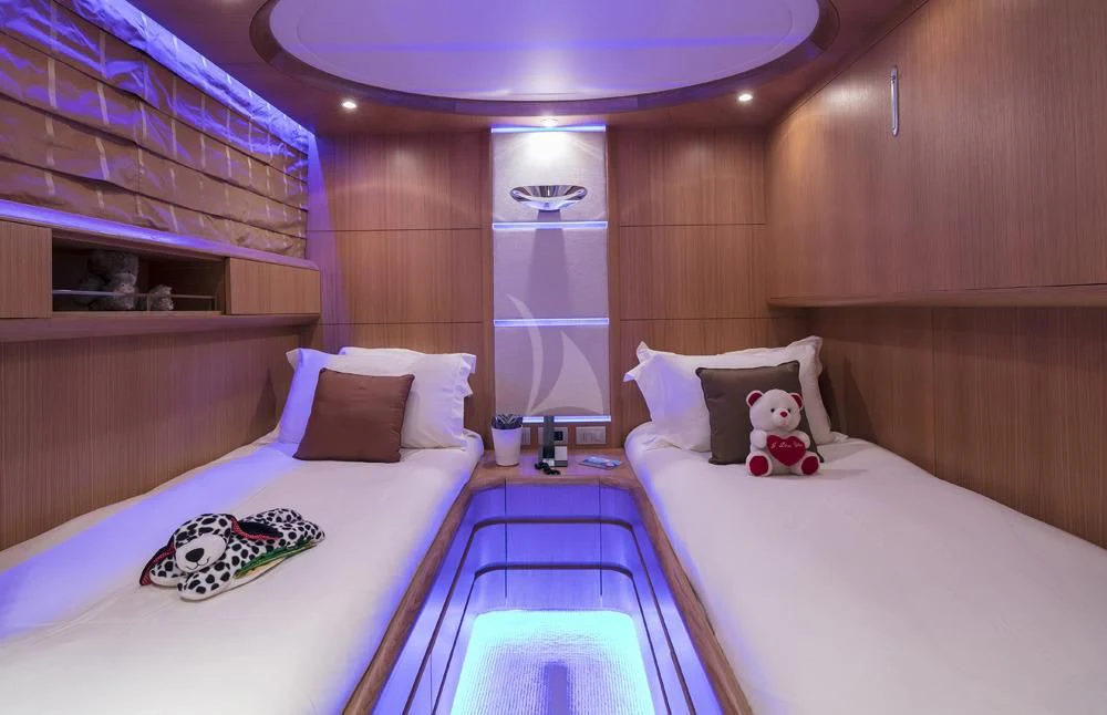 a room with beds and a plush toy aboard ANASA Yacht for Sale