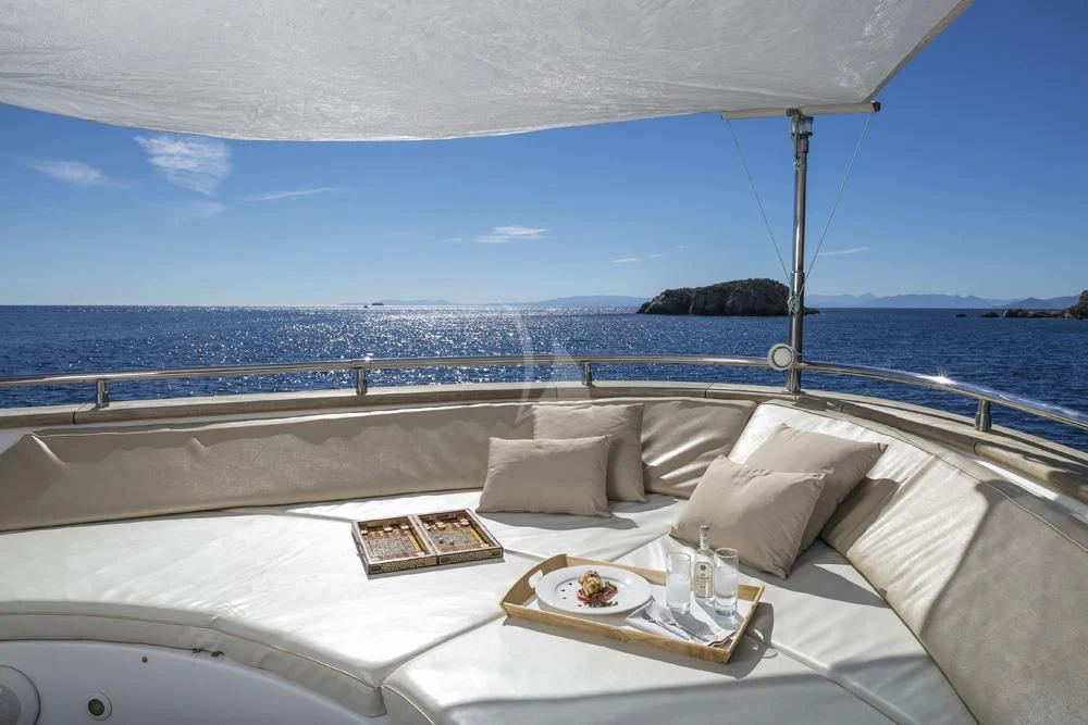 a bed with a tray of food on it aboard ANASA Yacht for Sale