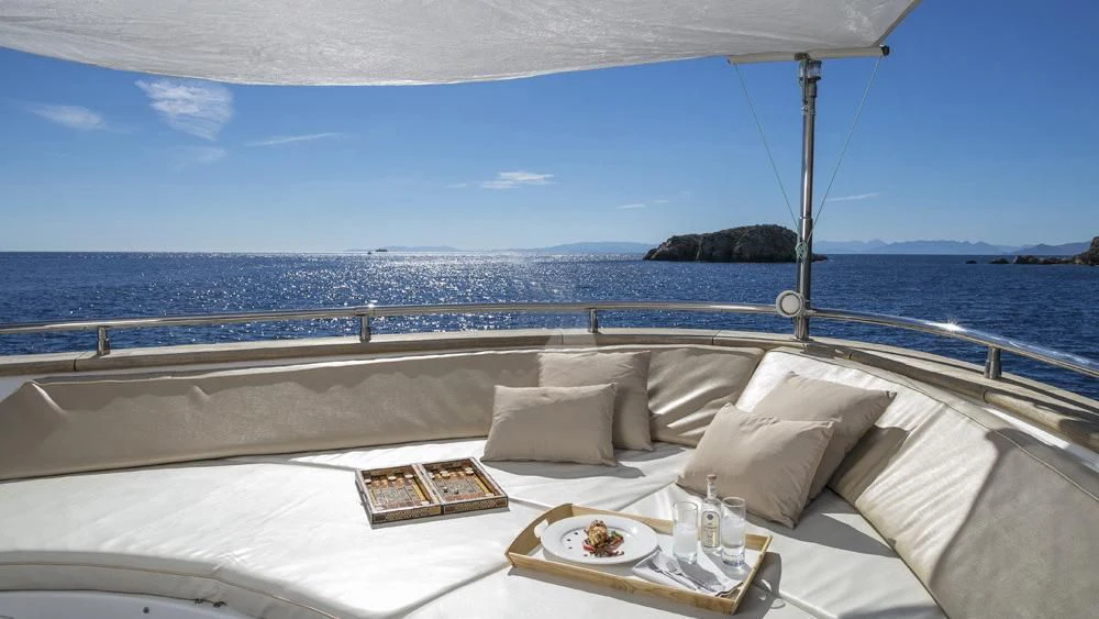 a bed with a tray of food on it aboard ANASA Yacht for Sale