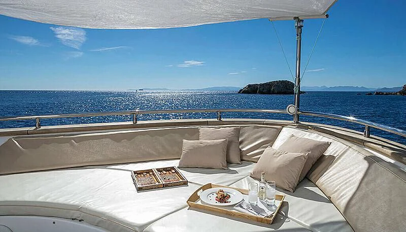 a bed with a tray of food on it aboard ANASA Yacht for Sale