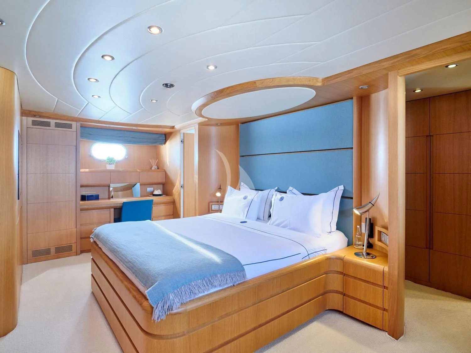 a bedroom with a bed and a desk aboard ANASA Yacht for Sale