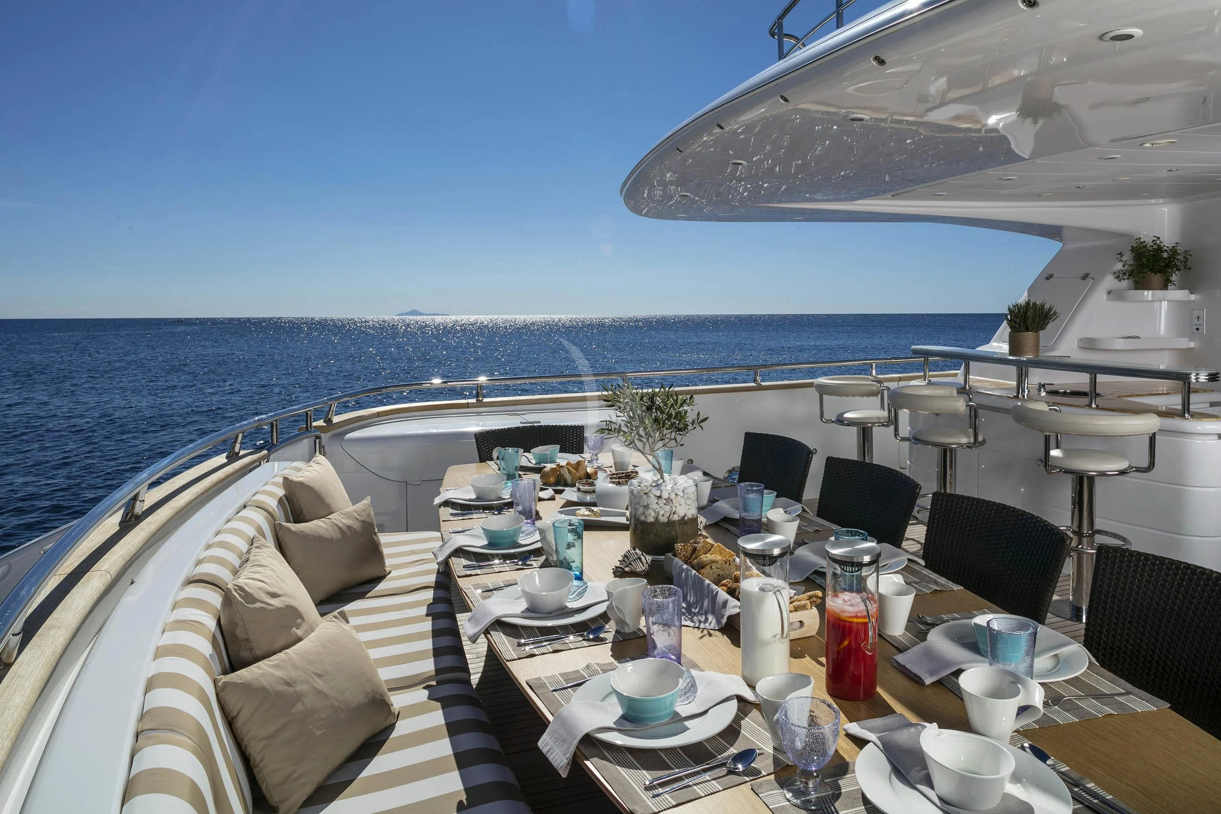 a table set for a meal on a beach aboard ANASA Yacht for Sale