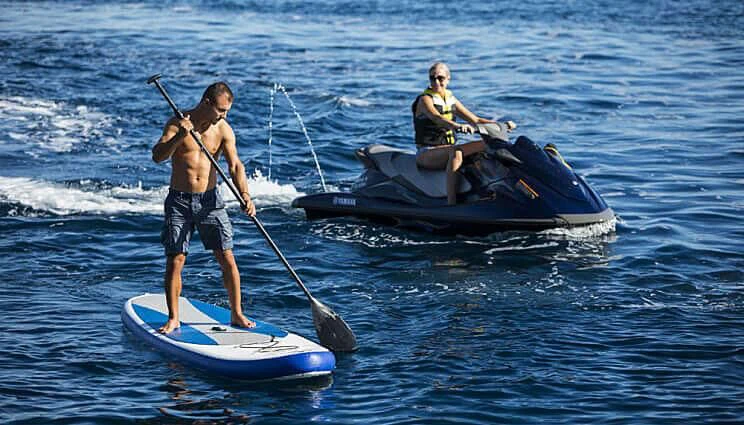 a couple of men on a paddle boat with a paddle aboard ANASA Yacht for Sale