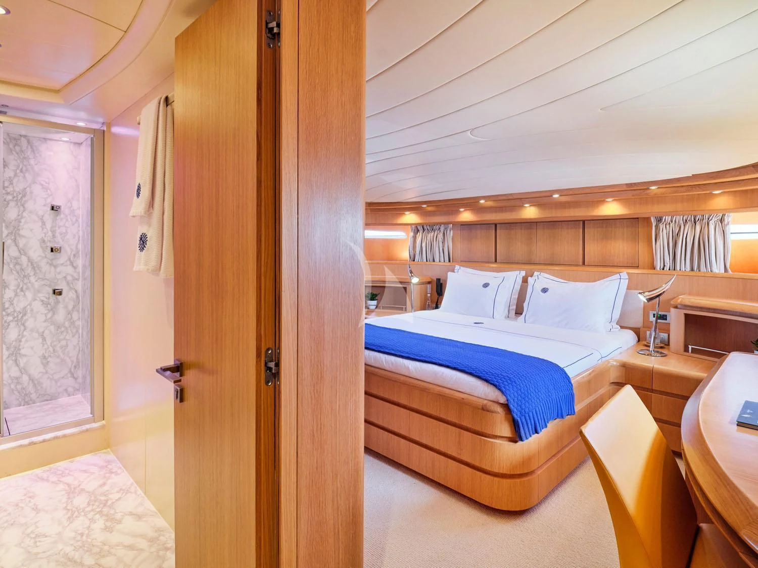 a bedroom with a bed and a door aboard ANASA Yacht for Sale