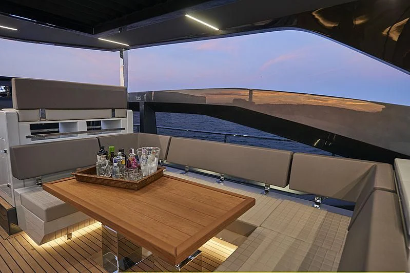 a room with a table and a bench aboard NINITAS A Yacht for Sale