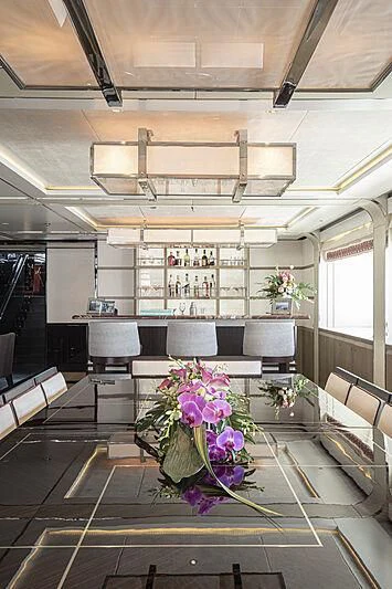 a room with a table and chairs aboard M5 Yacht for Sale