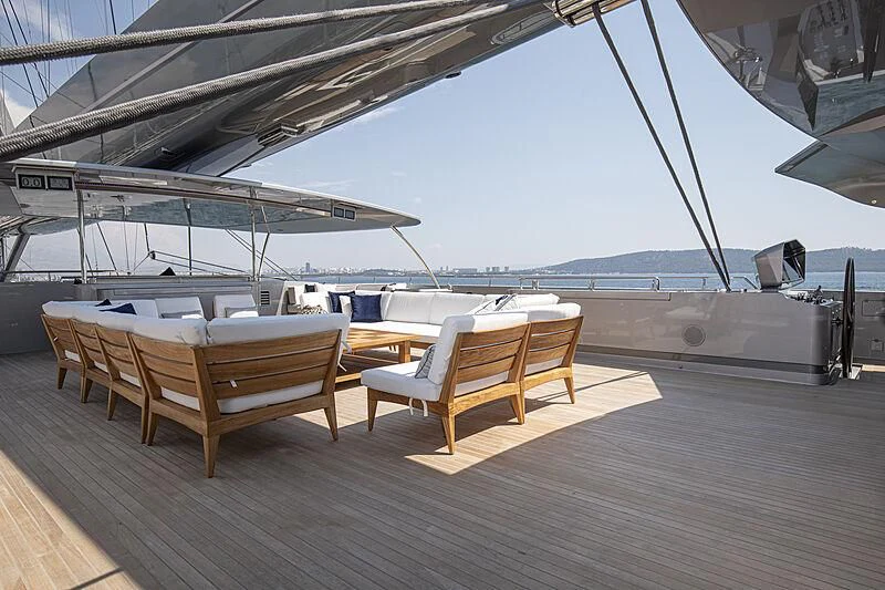 a deck with chairs on it aboard M5 Yacht for Sale