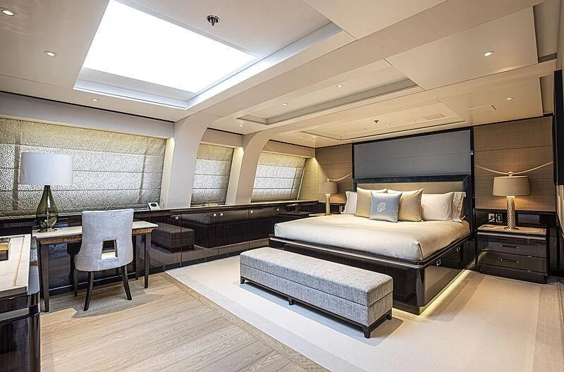 a large room with a bed and a desk aboard M5 Yacht for Sale