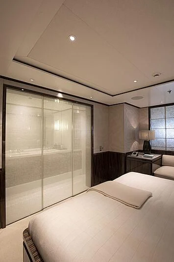 a bedroom with a glass door aboard M5 Yacht for Sale