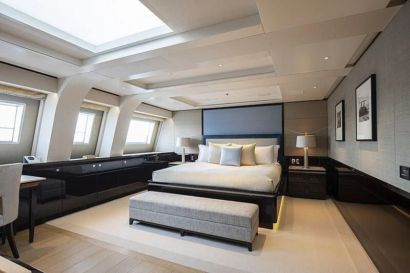 a large bedroom with a large bed aboard M5 Yacht for Sale