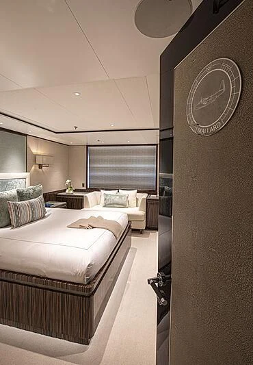 a room with a bed and a round clock aboard M5 Yacht for Sale