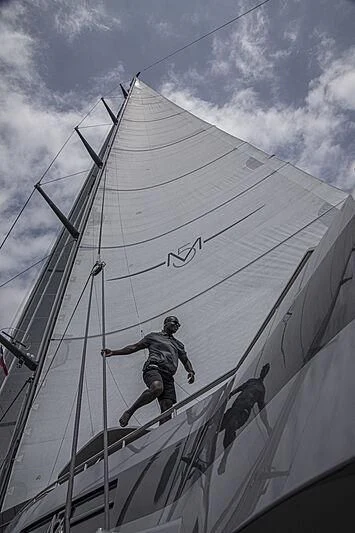 a man climbing a ladder on a boat aboard M5 Yacht for Sale