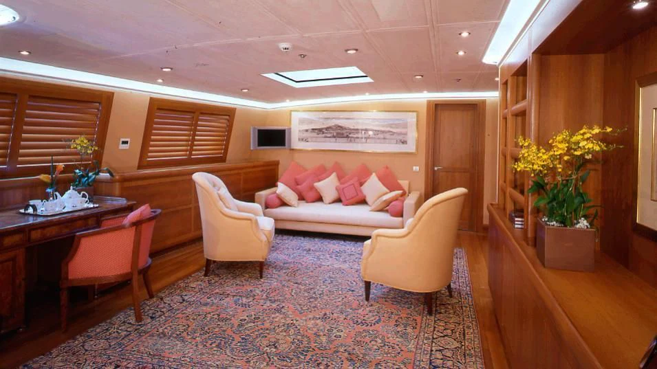 a living room with a couch and chairs aboard M5 Yacht for Sale