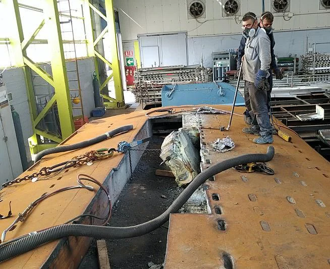 a couple of men working on a construction site aboard M5 Yacht for Sale