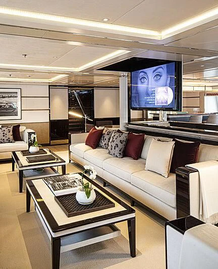 a living room with a large screen aboard M5 Yacht for Sale