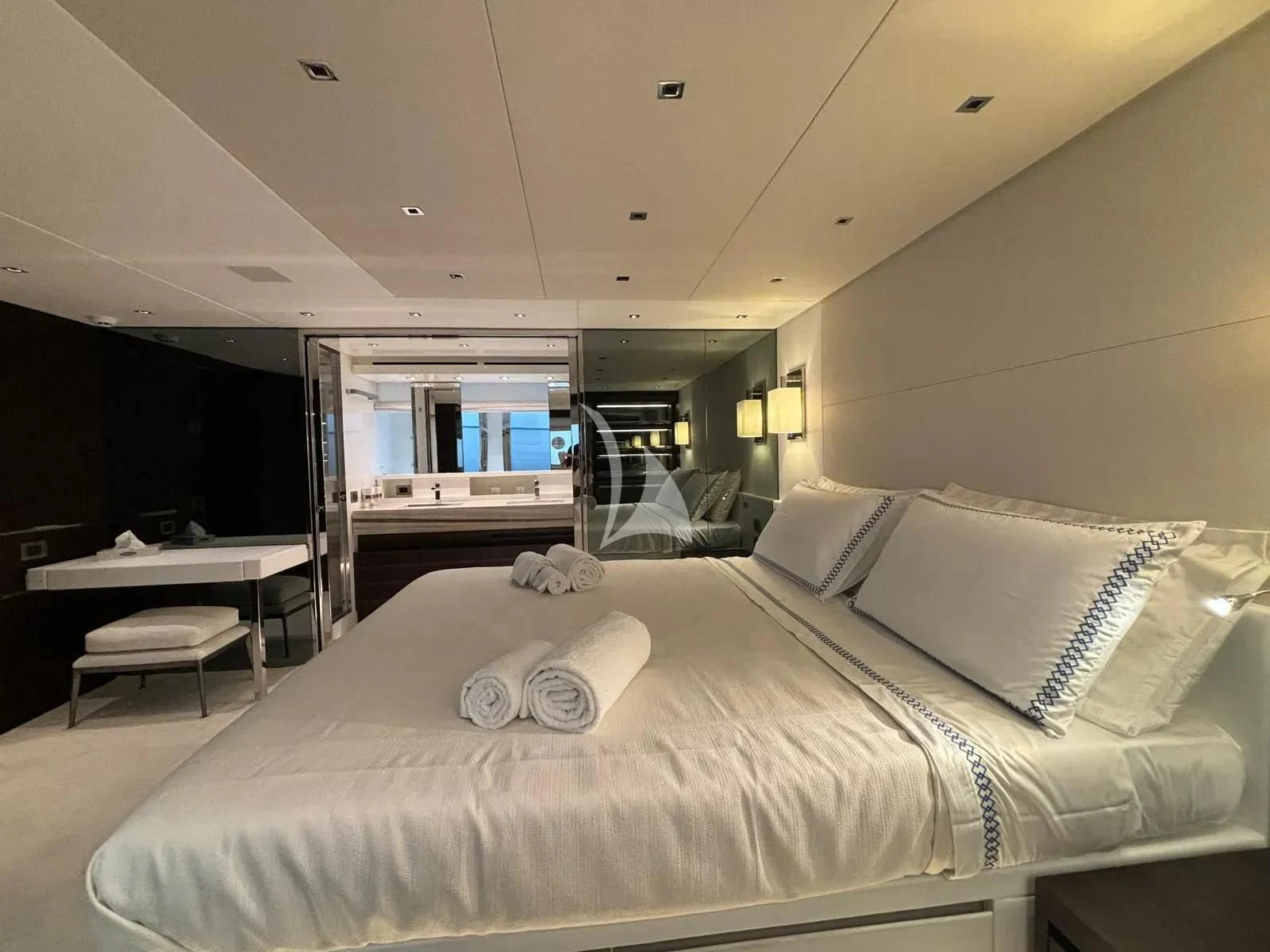 a bed with a white comforter aboard QUEEN MARTINA Yacht for Sale