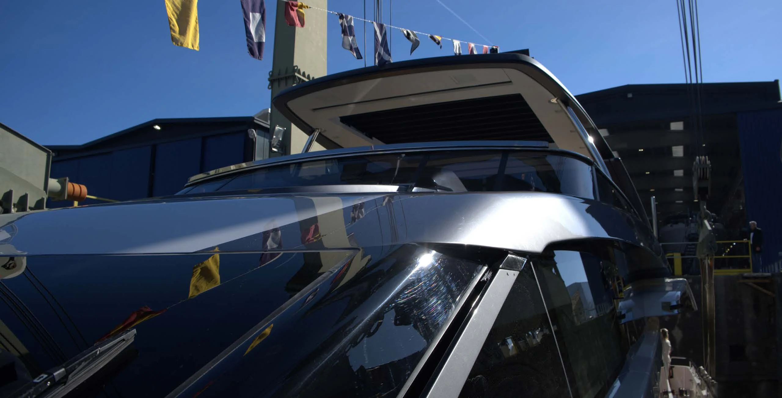 a blue car with a white hood aboard QUEEN MARTINA Yacht for Sale