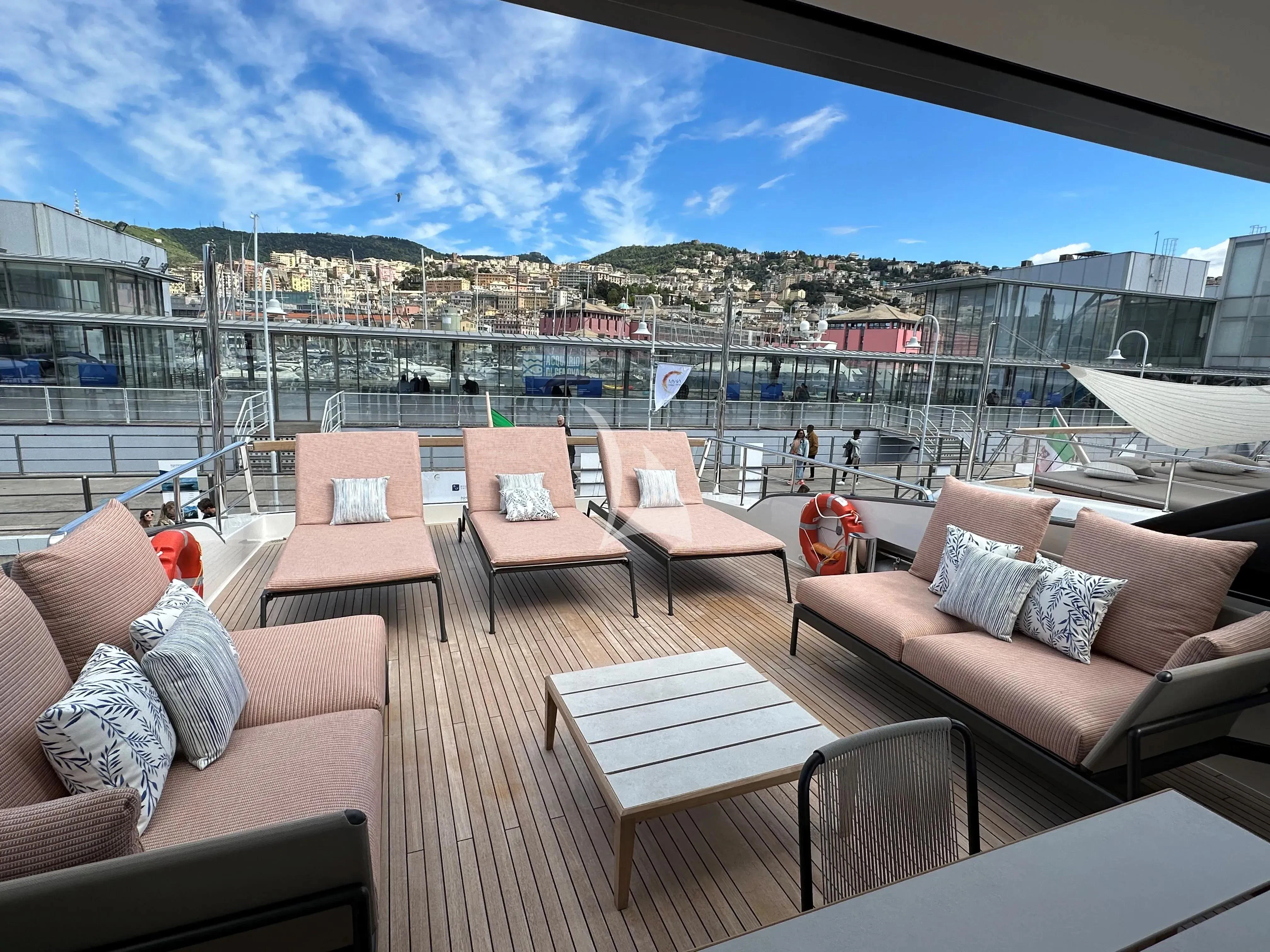a deck with chairs and tables aboard QUEEN MARTINA Yacht for Sale