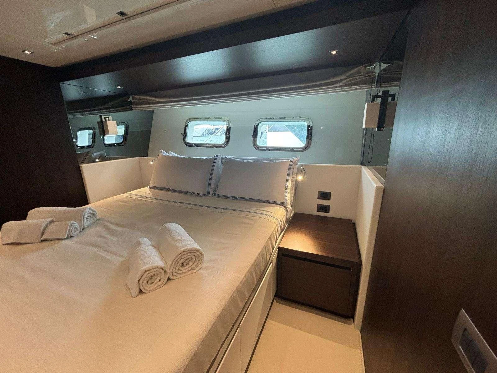 a room with a bed and a desk aboard QUEEN MARTINA Yacht for Sale