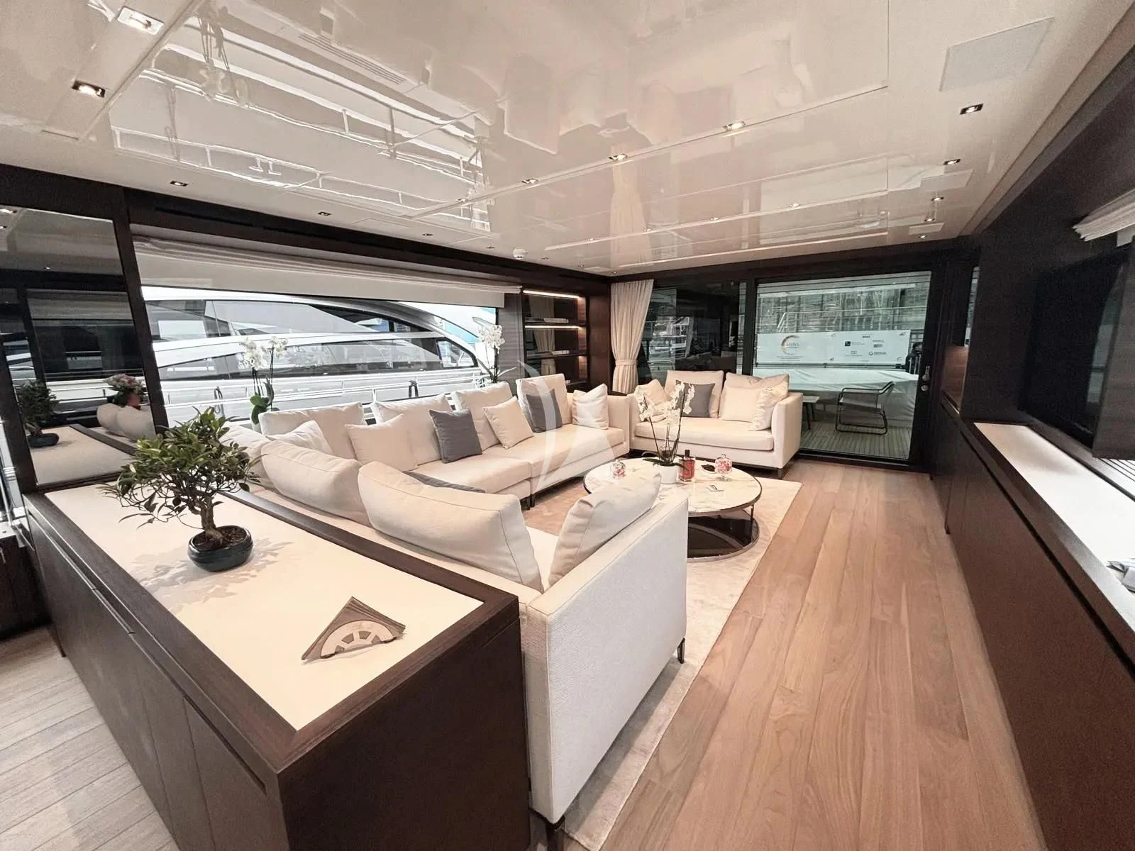 a modern living room with a large window aboard QUEEN MARTINA Yacht for Sale