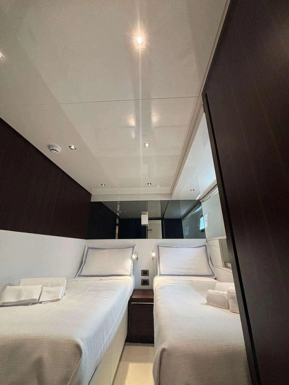 a room with a bed and a mirror aboard QUEEN MARTINA Yacht for Sale