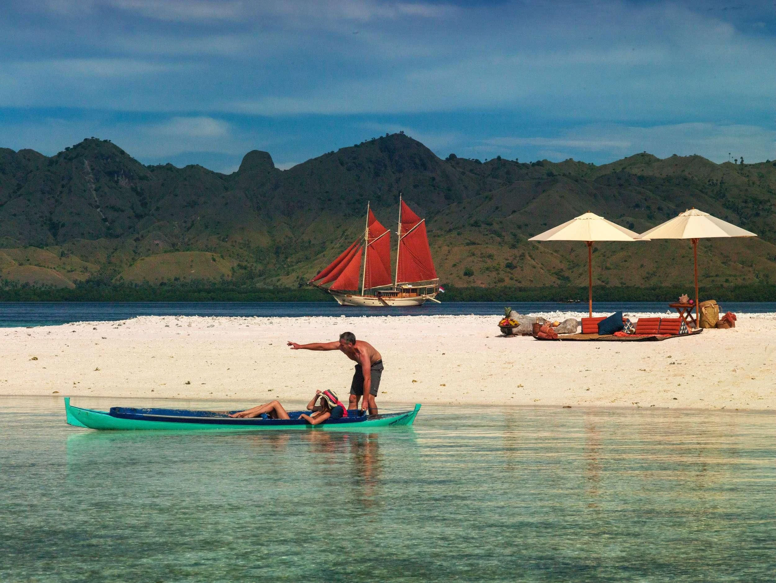 a person on a surfboard in the water aboard SI DATU BUA Yacht for Sale