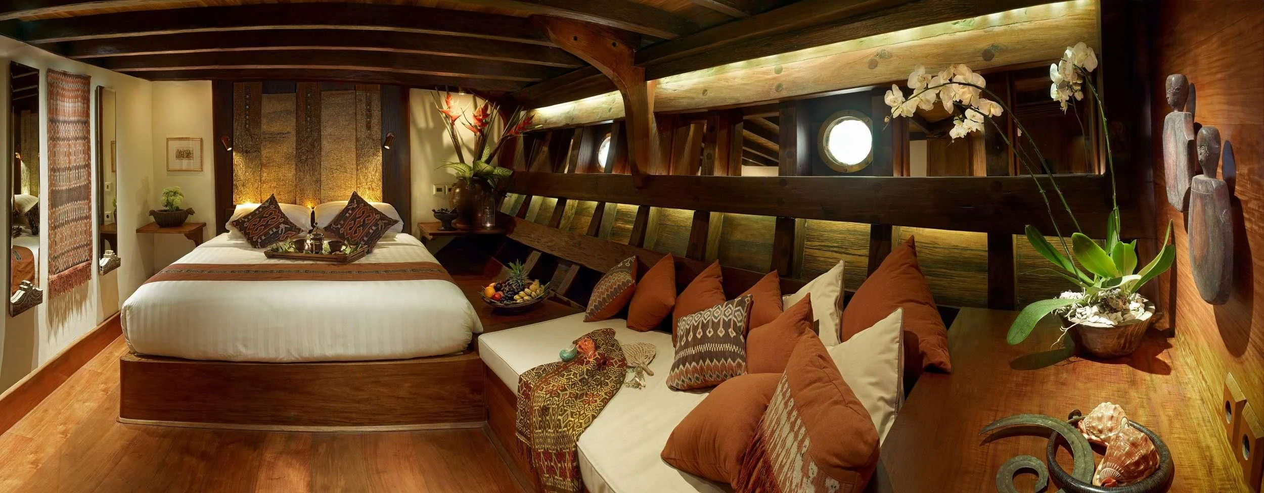 a room with a bed and a table with a plant aboard SI DATU BUA Yacht for Sale