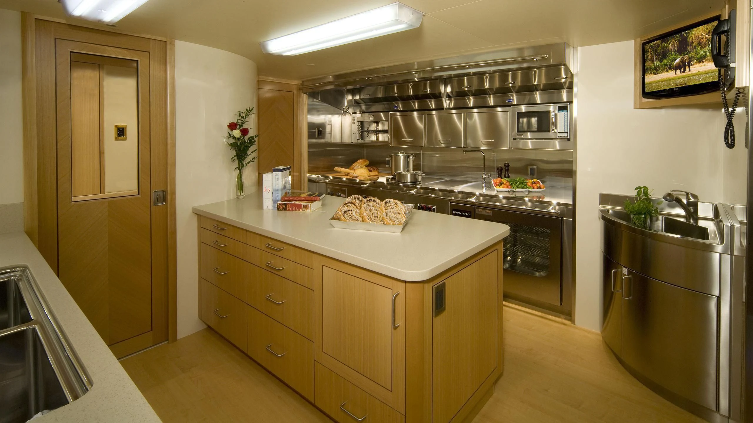 a kitchen with a large stainless steel stove and cabinets aboard SECOND LOVE Yacht for Charter