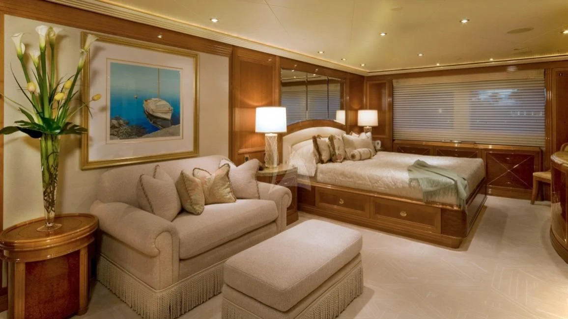 a large bedroom with a bed and a couch aboard SECOND LOVE Yacht for Charter