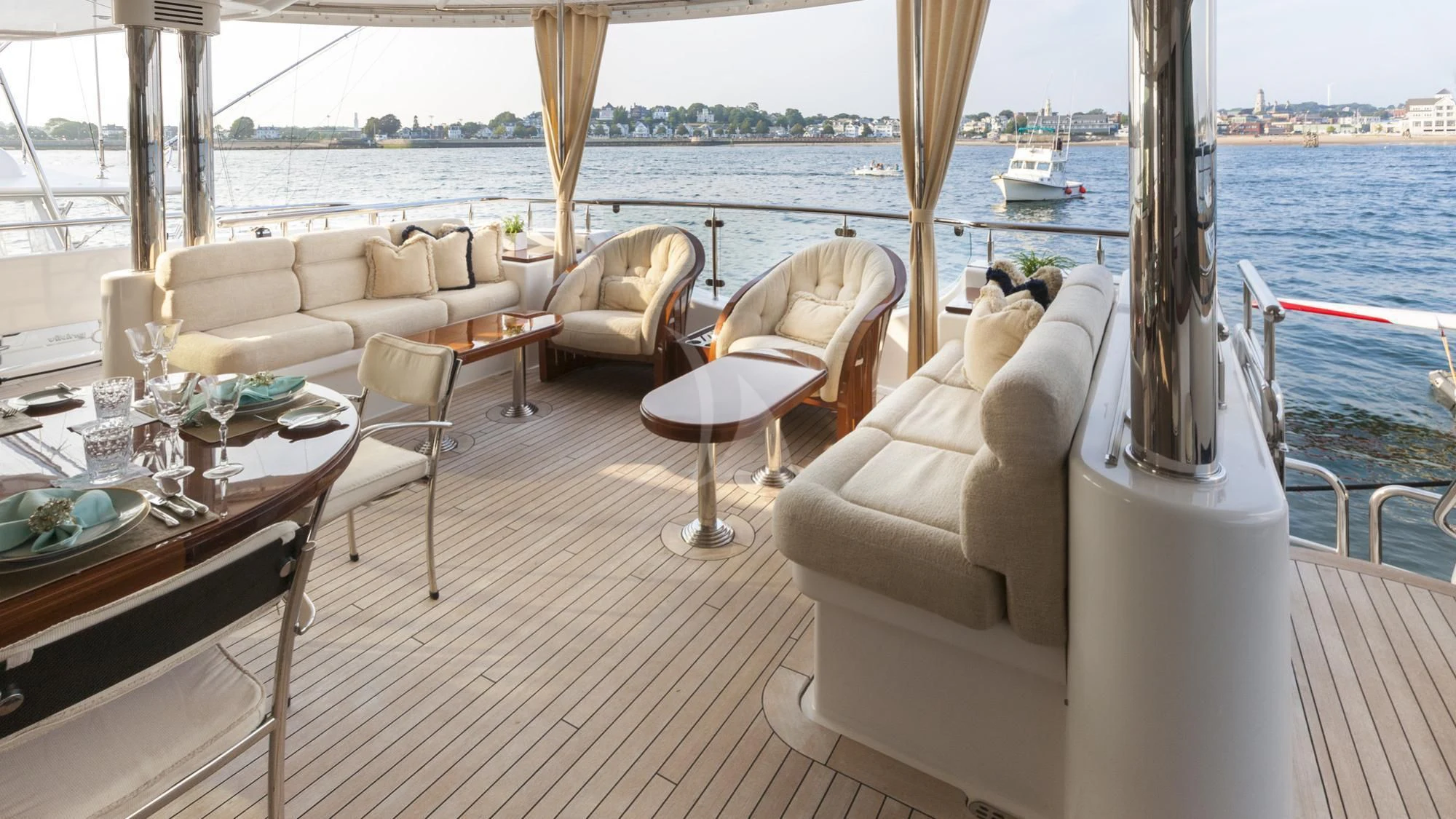 a room with a table chairs and a window with boats in the water aboard SECOND LOVE Yacht for Charter