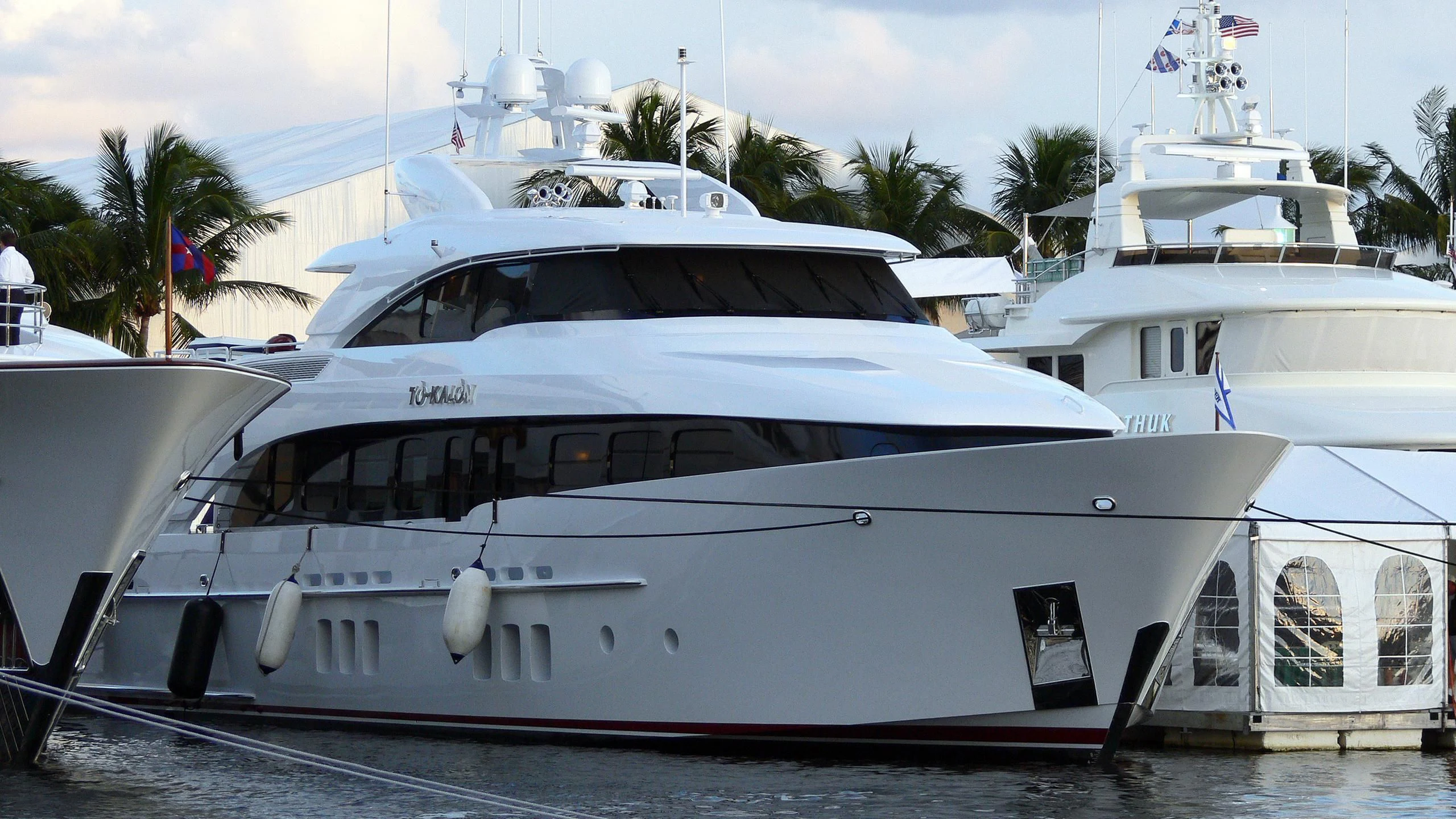 a white yacht on a dock aboard INDULGENCE Yacht for Sale
