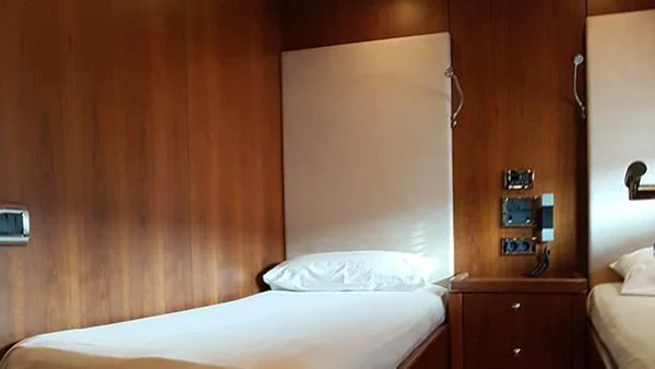 a bed with a white sheet aboard LAURA S Yacht for Sale