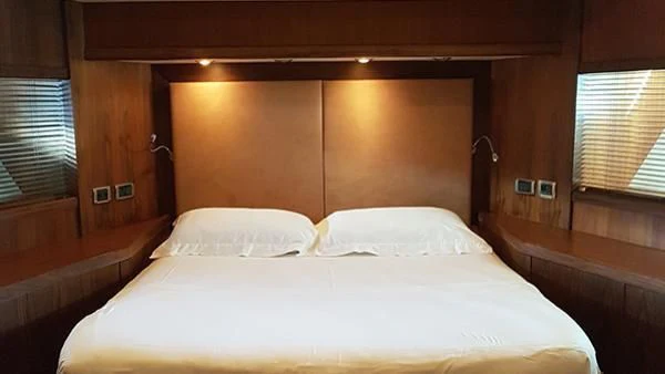 a bed with white sheets aboard LAURA S Yacht for Sale