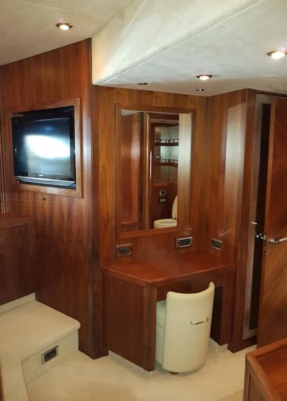 a room with a television and a cupboard aboard LAURA S Yacht for Sale