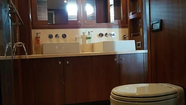 a bathroom with a toilet and a sink aboard LAURA S Yacht for Sale