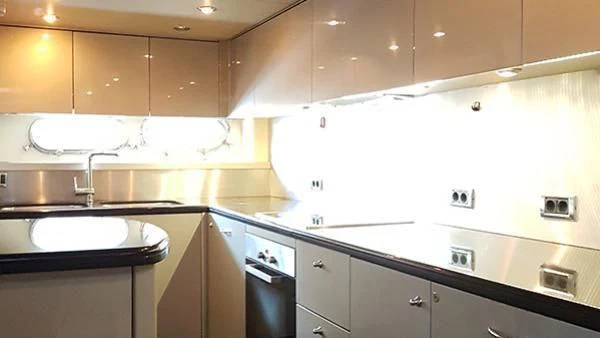 a kitchen with white cabinets aboard LAURA S Yacht for Sale