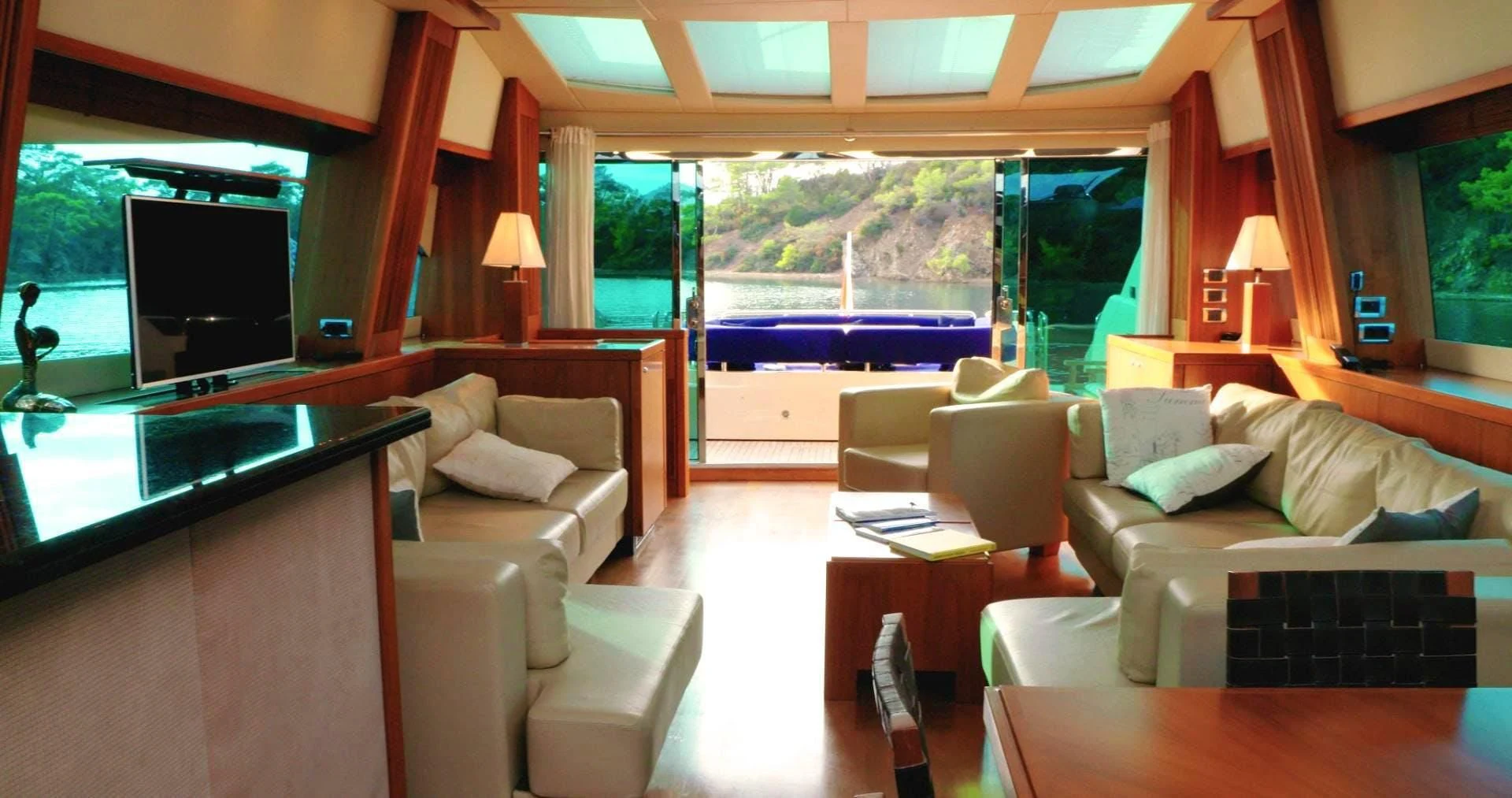 a living room with a large window aboard LAURA S Yacht for Sale