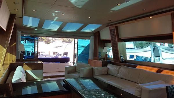a living room with a large window aboard LAURA S Yacht for Sale
