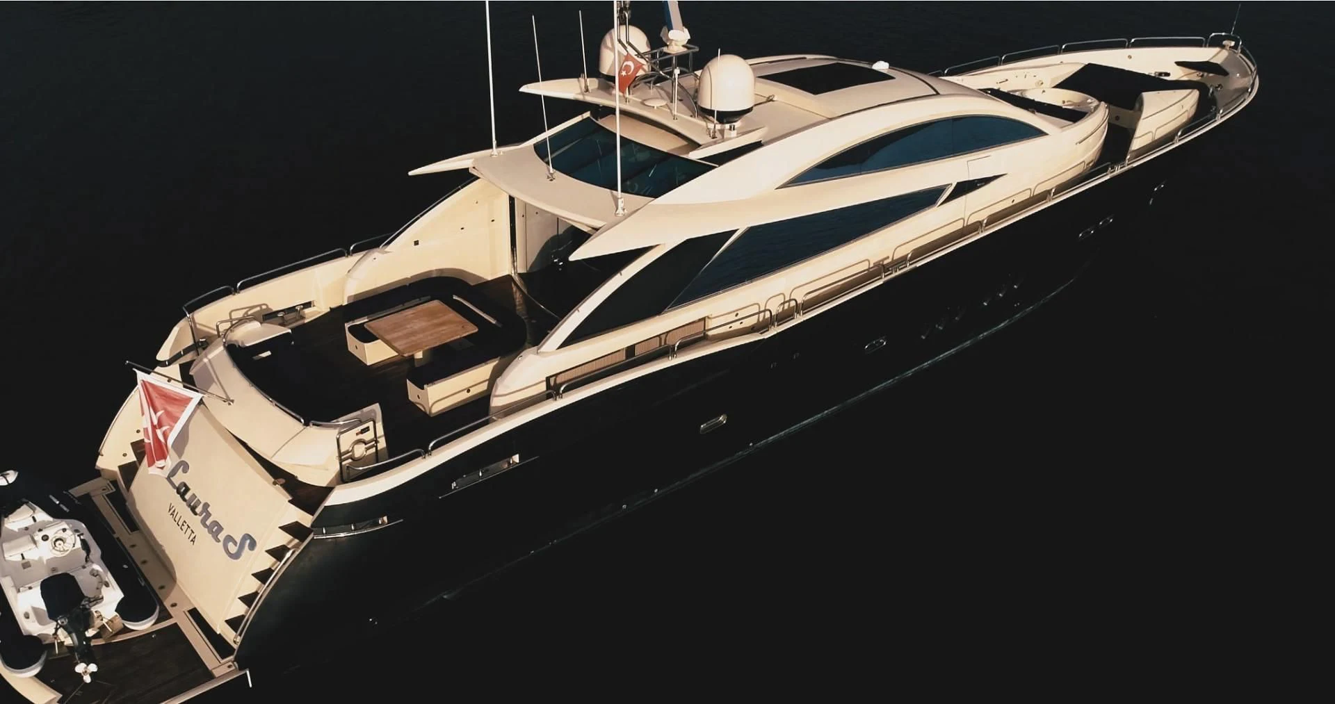a white boat with a red and black stripe on the front aboard LAURA S Yacht for Sale