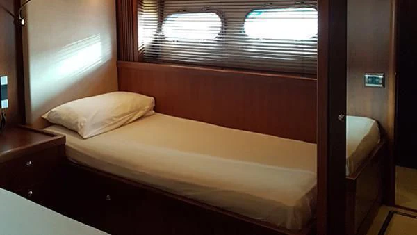 a bed with a white sheet aboard LAURA S Yacht for Sale