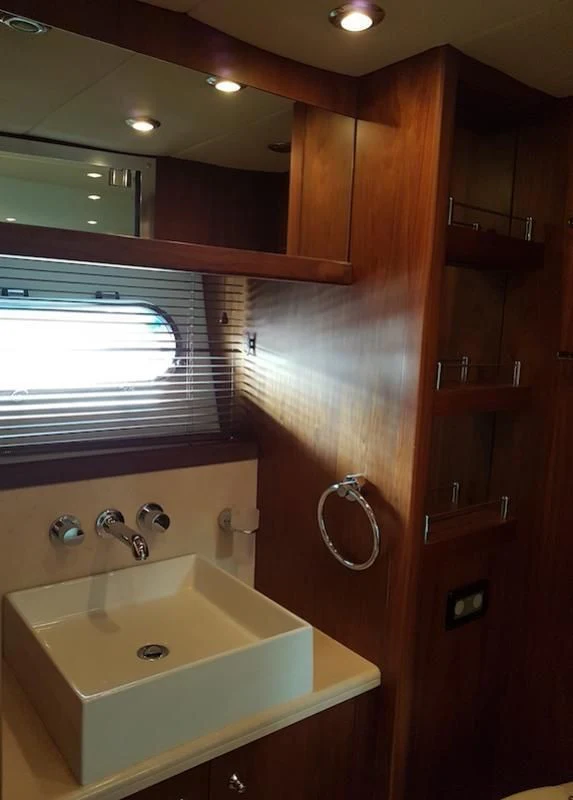 a bathroom with a sink and a mirror aboard LAURA S Yacht for Sale