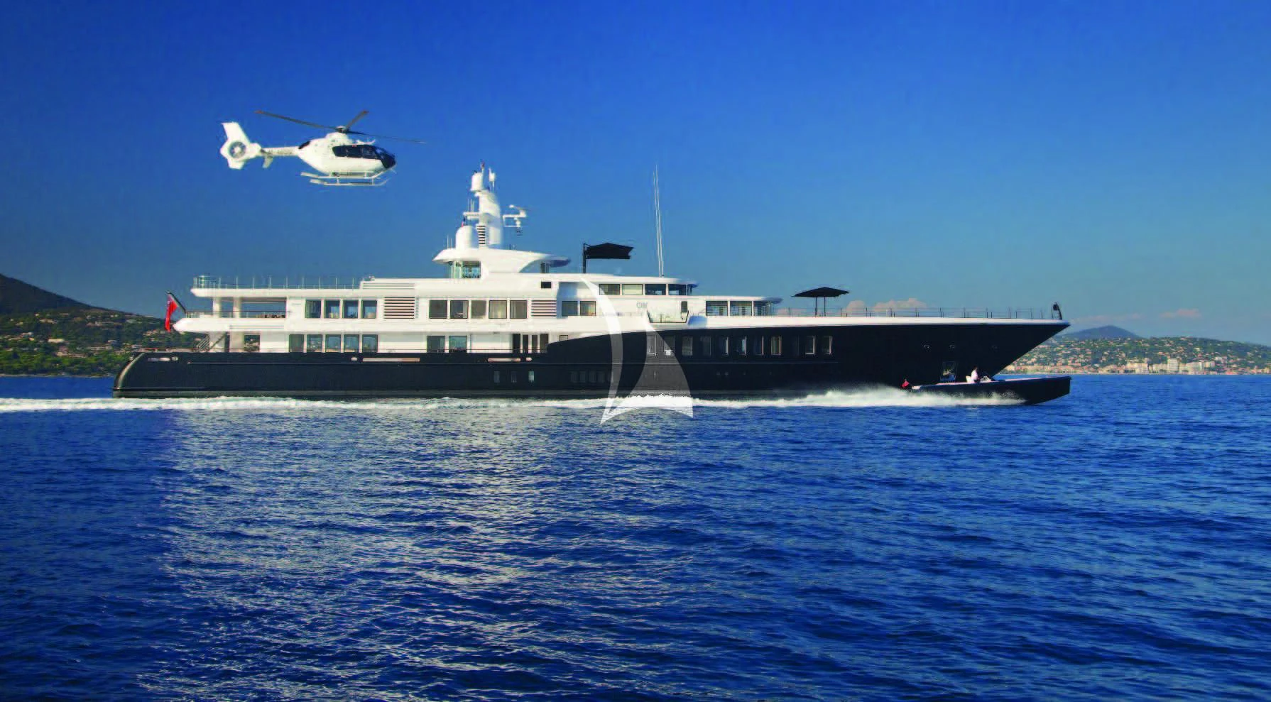 a helicopter flying over a boat aboard AIR Yacht for Sale