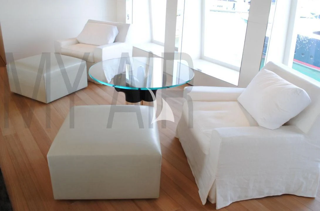 a room with a table and chairs aboard AIR Yacht for Sale