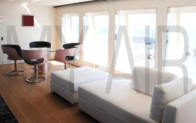 a room with a bed and a table and chairs aboard AIR Yacht for Sale