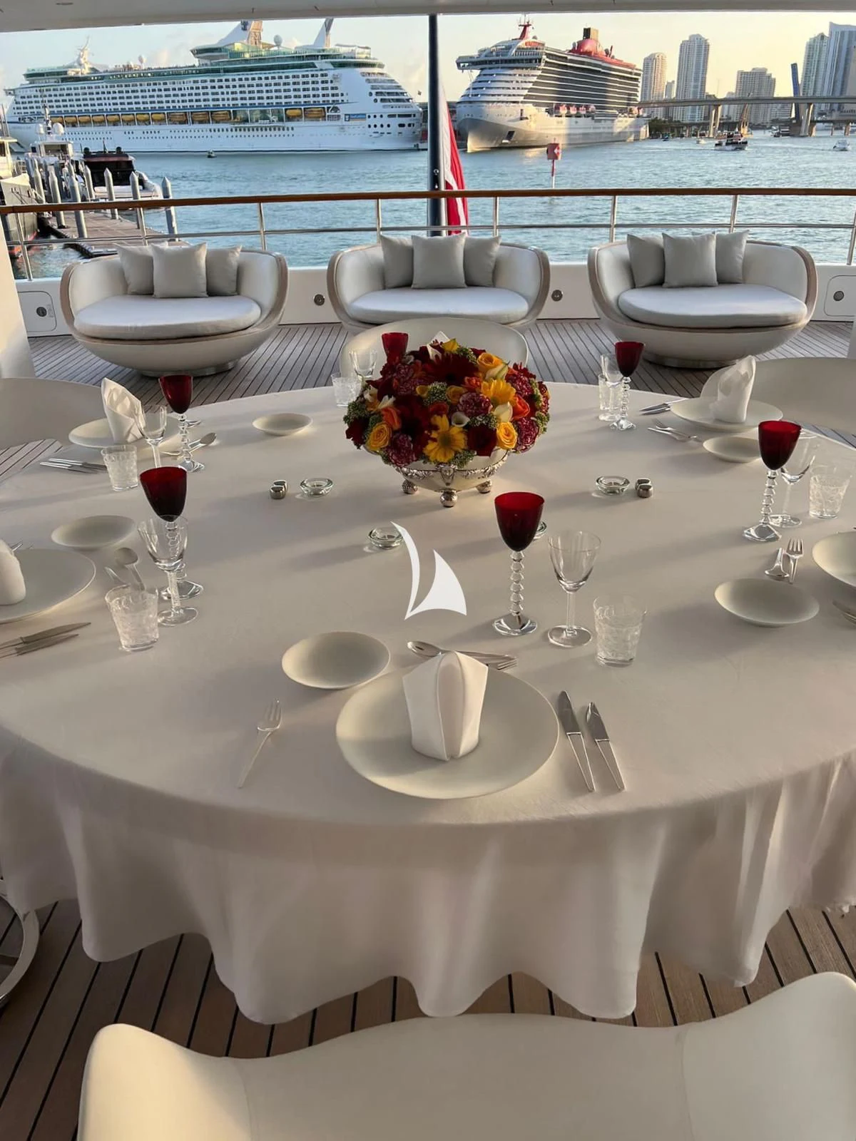 a table with plates and glasses on it aboard AIR Yacht for Sale